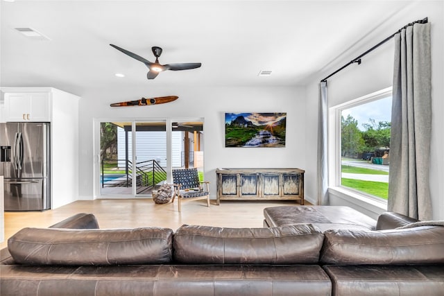 living room featuring ceiling fan and light hardwood / wood-style flooring