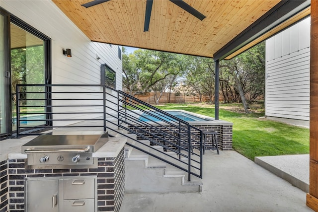 view of patio / terrace with area for grilling, ceiling fan, and a grill