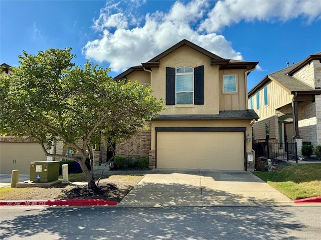 view of front facade with concrete driveway, stucco siding, and a garage