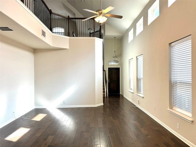 unfurnished living room with a ceiling fan, high vaulted ceiling, wood finished floors, and plenty of natural light