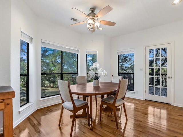 dining room with a wealth of natural light, hardwood / wood-style floors, and ceiling fan