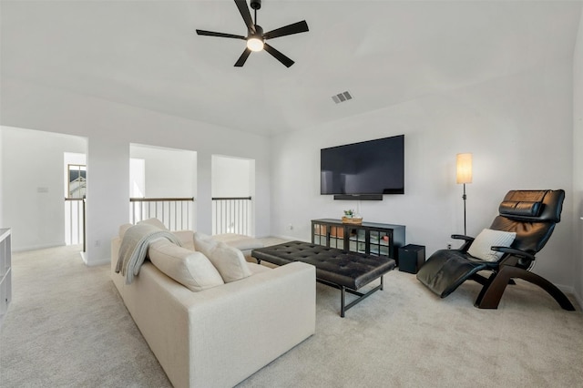 carpeted living room with ceiling fan