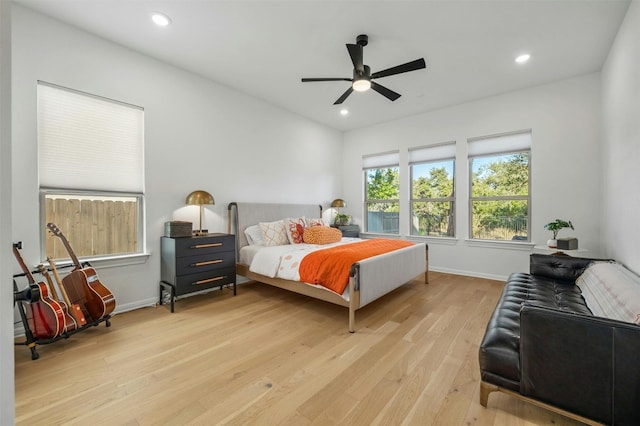 bedroom with ceiling fan and light wood-type flooring