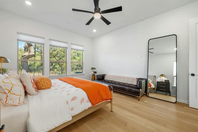 bedroom with ceiling fan and light hardwood / wood-style flooring