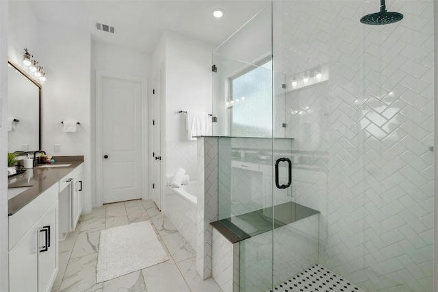 bathroom with vanity and independent shower and bath