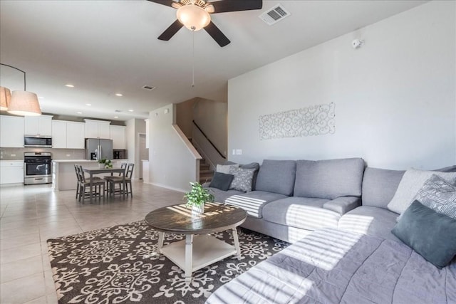 3925 Lyndsey Marie Ln, Pflugerville, TX 78660 - living area featuring a ceiling fan, stairs, visible vents, and light tile patterned floors