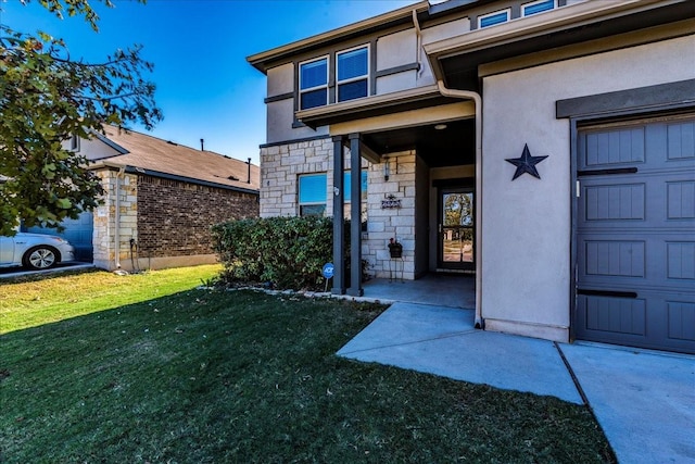 entrance to property with a lawn