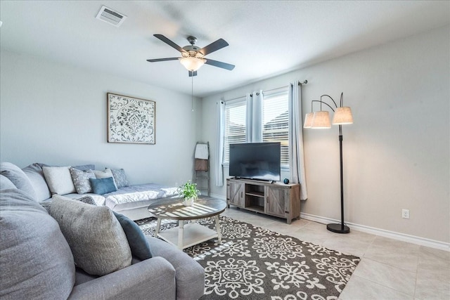 tiled living room featuring ceiling fan