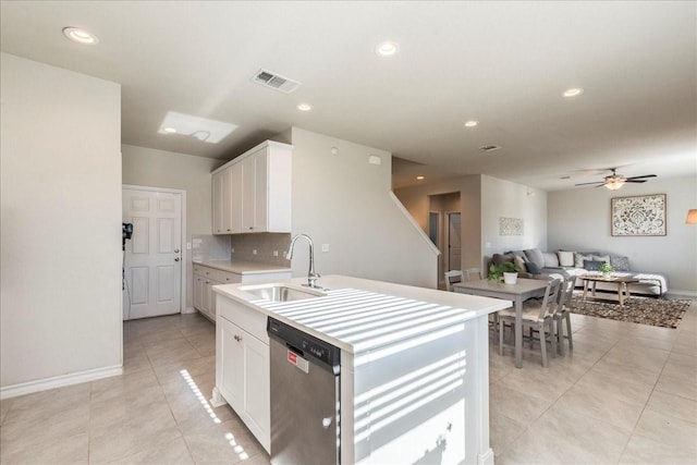 kitchen featuring sink, white cabinetry, dishwasher, ceiling fan, and light tile patterned floors