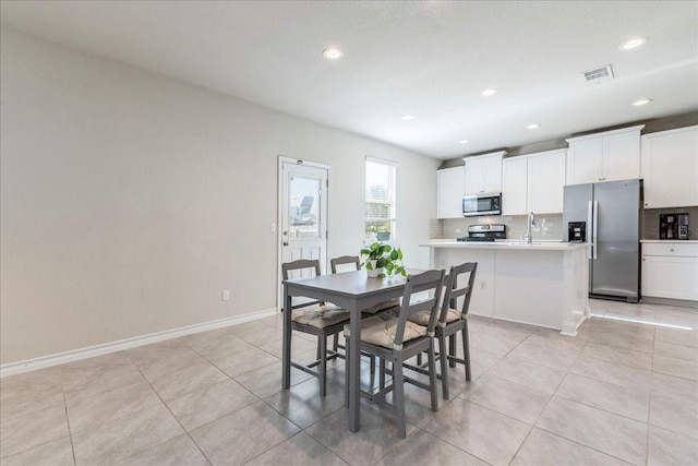 tiled dining area featuring sink