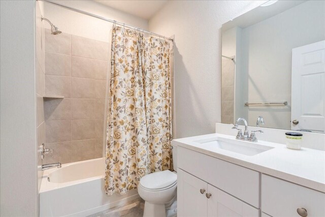 full bathroom with shower / bath combination with curtain, vanity, and toilet