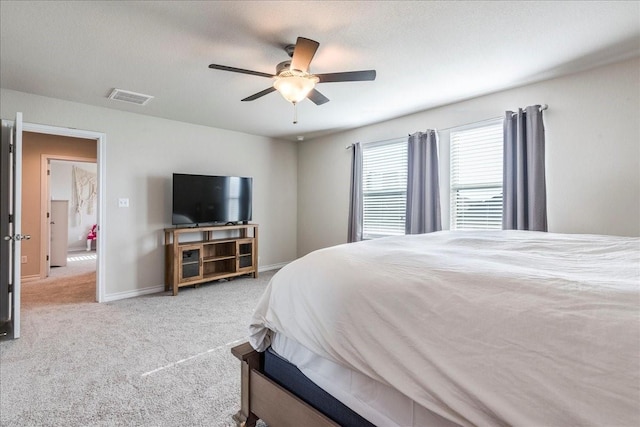 bedroom featuring light colored carpet and ceiling fan