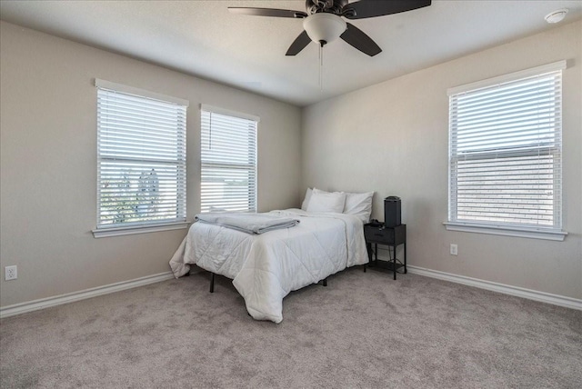 bedroom featuring ceiling fan and light colored carpet