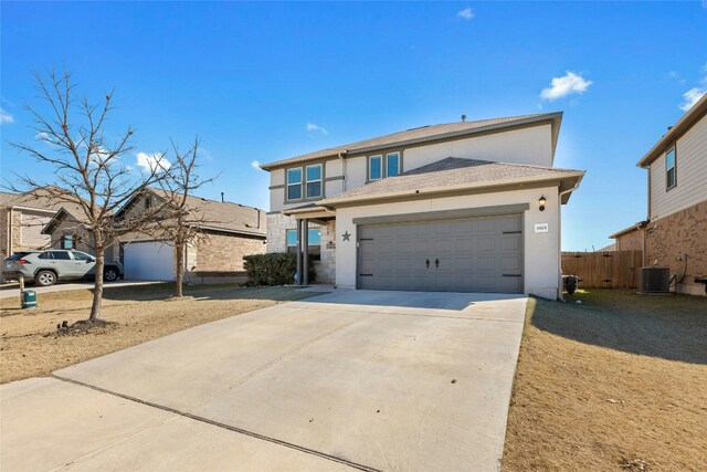 3925 Lyndsey Marie Ln, Pflugerville, TX 78660 - traditional-style home with central air condition unit, concrete driveway, fence, a garage, and stucco siding