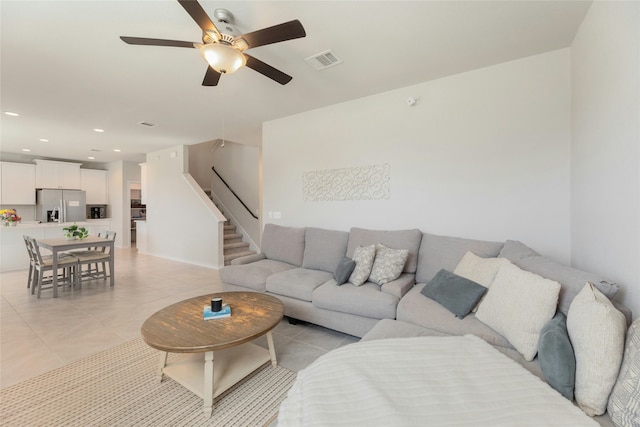 living room featuring ceiling fan and light tile patterned flooring