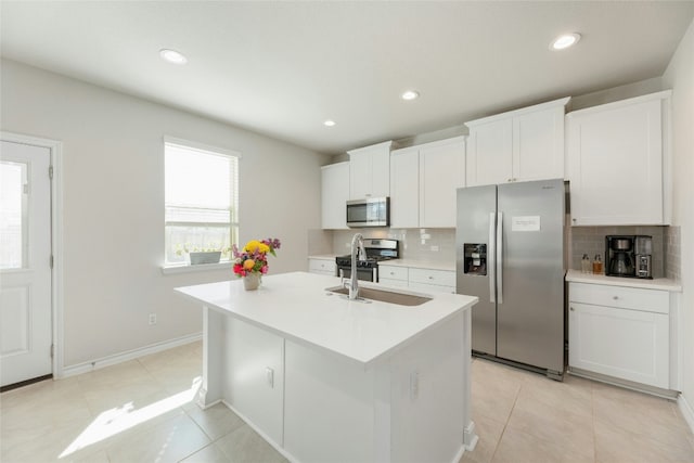 3925 Lyndsey Marie Ln, Pflugerville, TX 78660 - kitchen featuring white cabinets, decorative backsplash, an island with sink, and appliances with stainless steel finishes