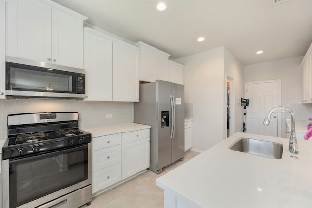 3925 Lyndsey Marie Ln, Pflugerville, TX 78660 - kitchen featuring white cabinets, stainless steel appliances, light countertops, a sink, and tasteful backsplash