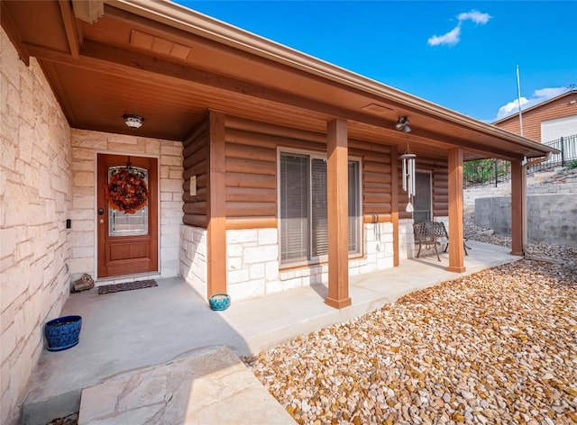 doorway to property featuring a porch