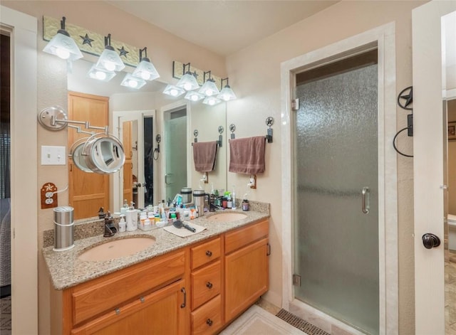 bathroom featuring vanity and an enclosed shower