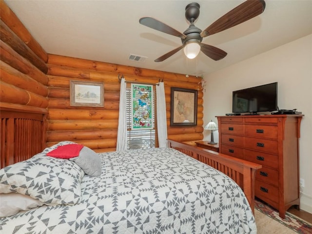 bedroom featuring ceiling fan, rustic walls, and access to outside