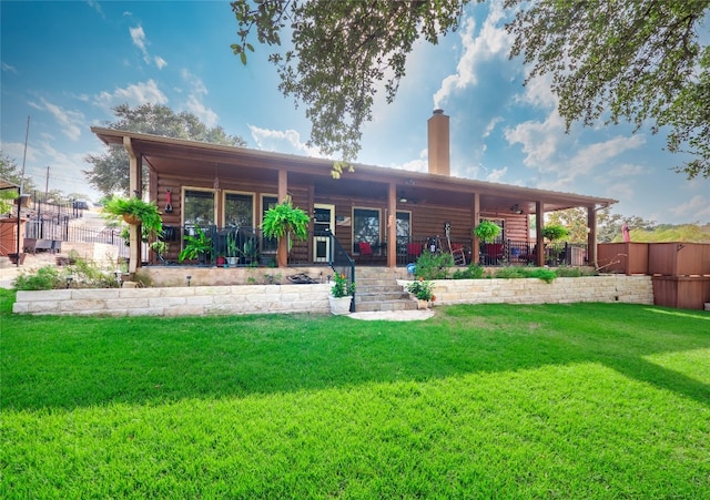 back of house featuring a lawn