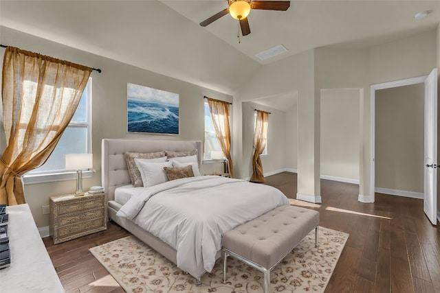 bedroom with vaulted ceiling, ceiling fan, and dark wood-type flooring