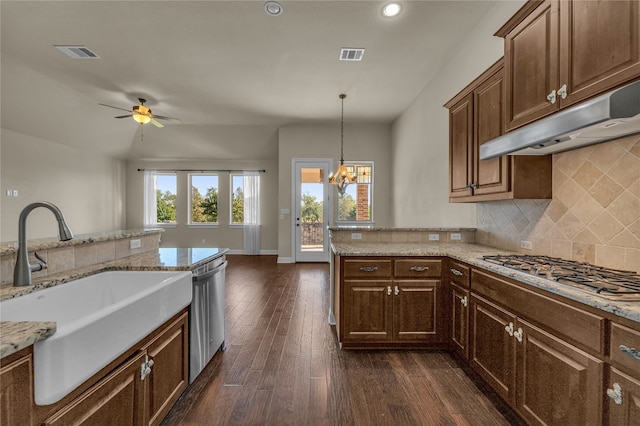 kitchen featuring backsplash, ceiling fan with notable chandelier, sink, dark hardwood / wood-style floors, and appliances with stainless steel finishes