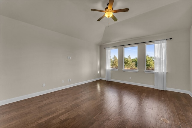 spare room featuring ceiling fan, dark wood-type flooring, and lofted ceiling