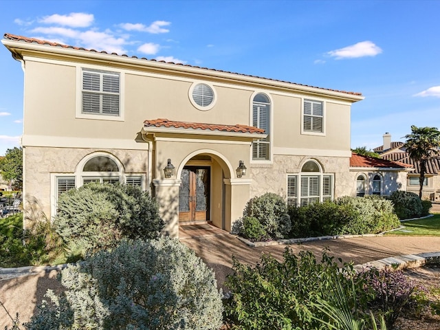 mediterranean / spanish-style home featuring french doors