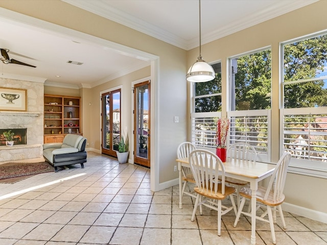 tiled dining space with a healthy amount of sunlight and crown molding