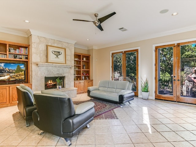 living room featuring a high end fireplace, french doors, built in shelves, light tile patterned floors, and ornamental molding