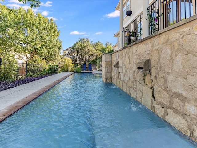 view of swimming pool featuring pool water feature