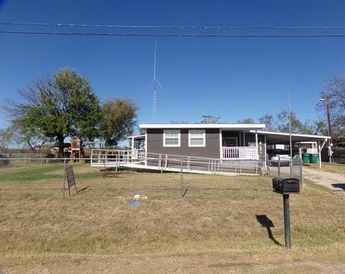 view of front of property featuring a carport and a front lawn