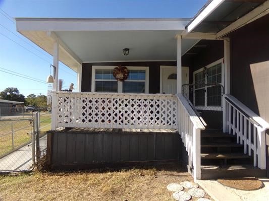 view of exterior entry with covered porch