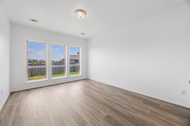 spare room with light hardwood / wood-style flooring