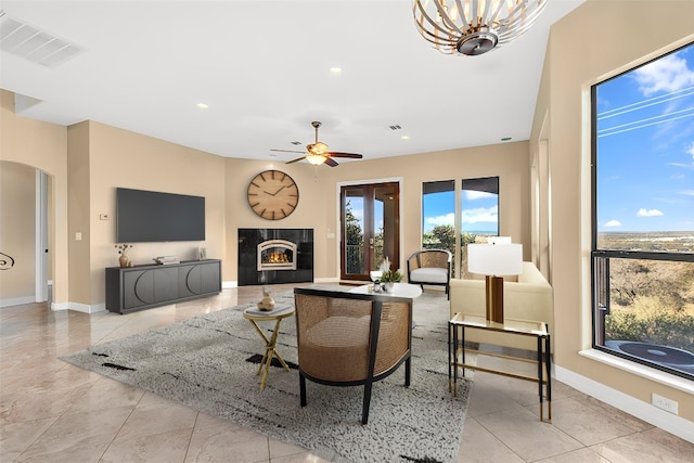 tiled living room with ceiling fan