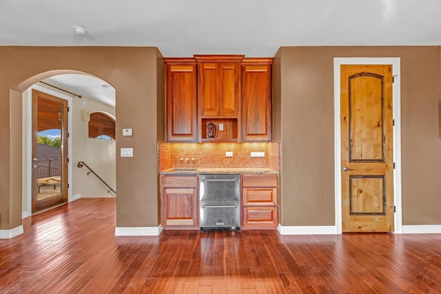 kitchen featuring decorative backsplash, sink, and dark wood-type flooring