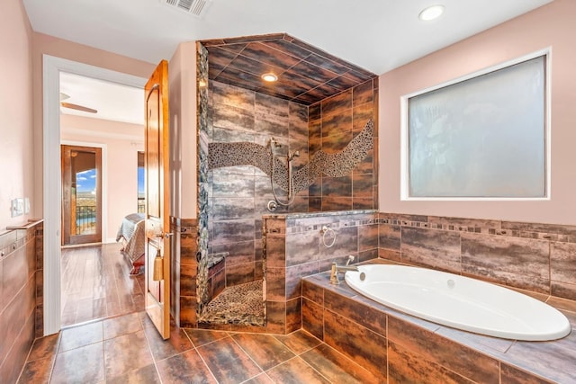 bathroom featuring tile walls and independent shower and bath