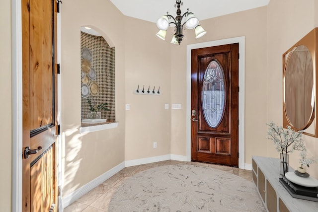 entryway featuring light tile patterned floors and a chandelier