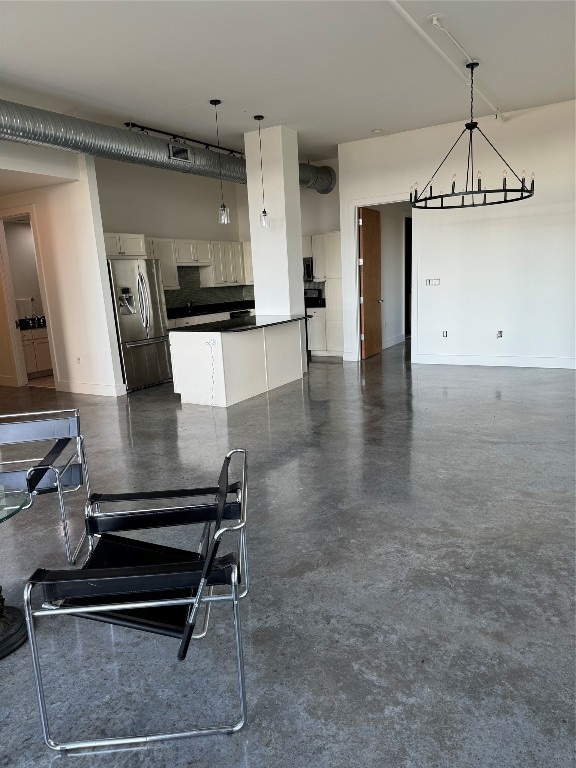 kitchen featuring white cabinetry, decorative light fixtures, and stainless steel refrigerator with ice dispenser