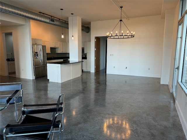 kitchen with white cabinetry, plenty of natural light, decorative light fixtures, and stainless steel refrigerator with ice dispenser