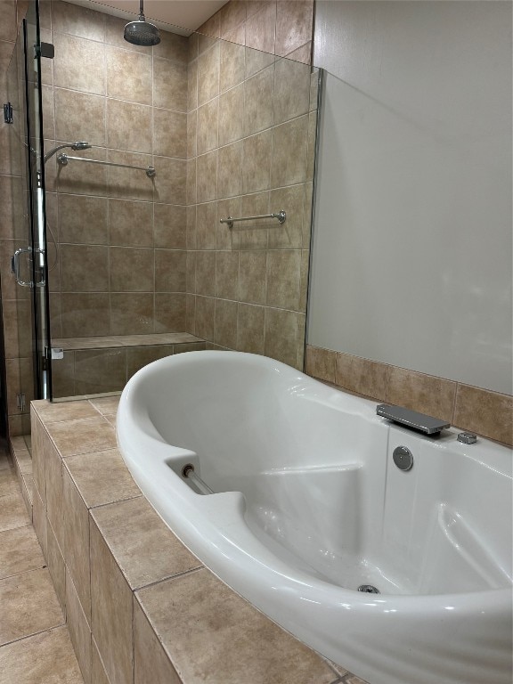 bathroom featuring tile patterned flooring and separate shower and tub