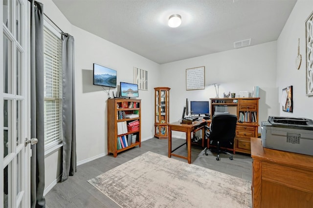 office featuring hardwood / wood-style floors and a textured ceiling