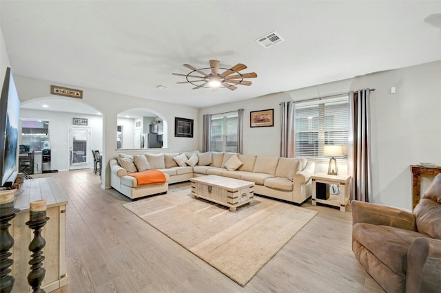 living room with ceiling fan and light hardwood / wood-style floors