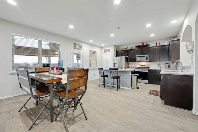 dining room featuring light hardwood / wood-style floors and sink