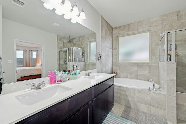 bathroom with tile patterned floors, vanity, shower with separate bathtub, and tile walls