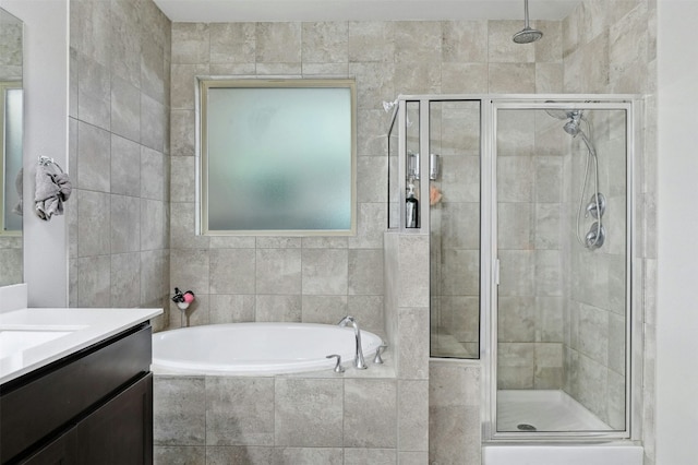 bathroom featuring vanity, separate shower and tub, and tile walls