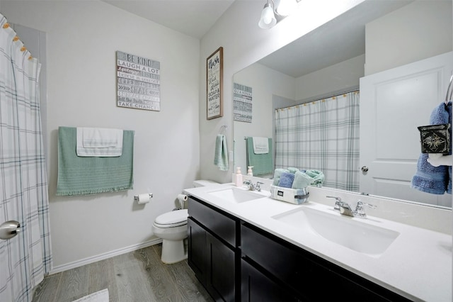 bathroom featuring hardwood / wood-style floors, vanity, and toilet