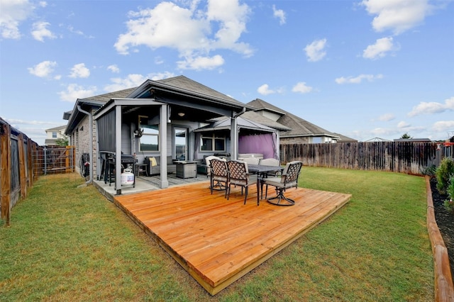 rear view of property featuring a yard and a wooden deck