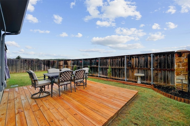 wooden deck featuring a lawn